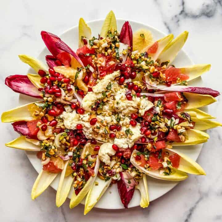 endive salad bites with grilled feta on a white plate