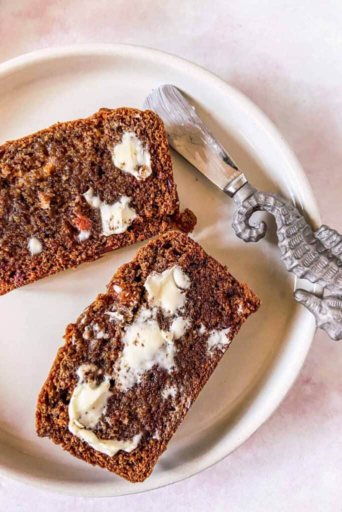 slices of persimmon bread on a plate with butter on top