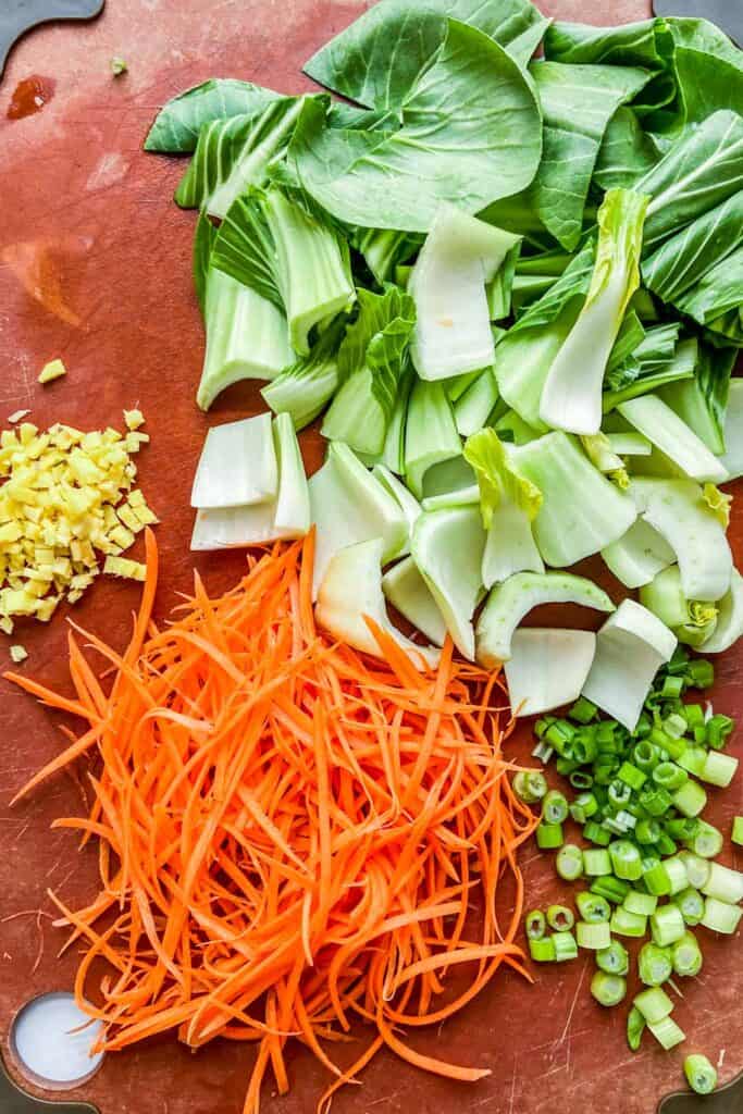 chopped carrots, ginger, spring onions, and bok choy