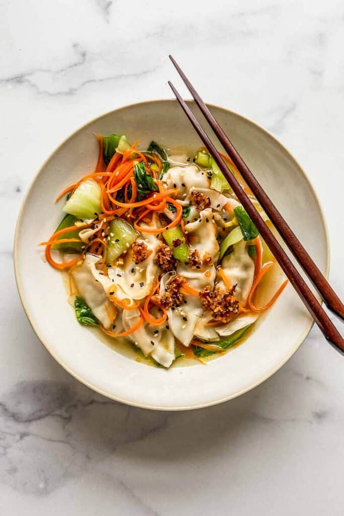 gyoza soup in a bowl with chopsticks