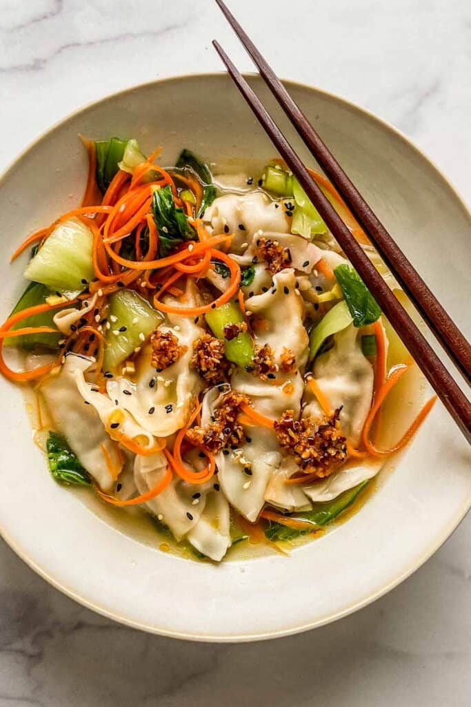 dumpling soup in a bowl with chopsticks