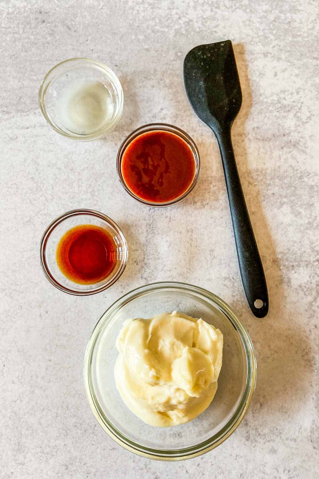 Spicy mayo ingredients with a small spatula.