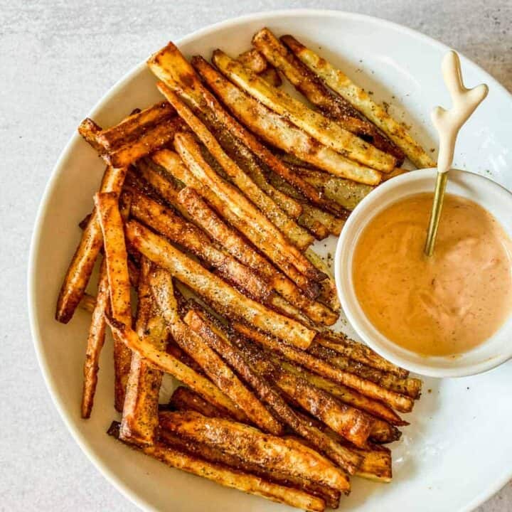 Togarashi fries in a white bowl with a side of spicy mayo.