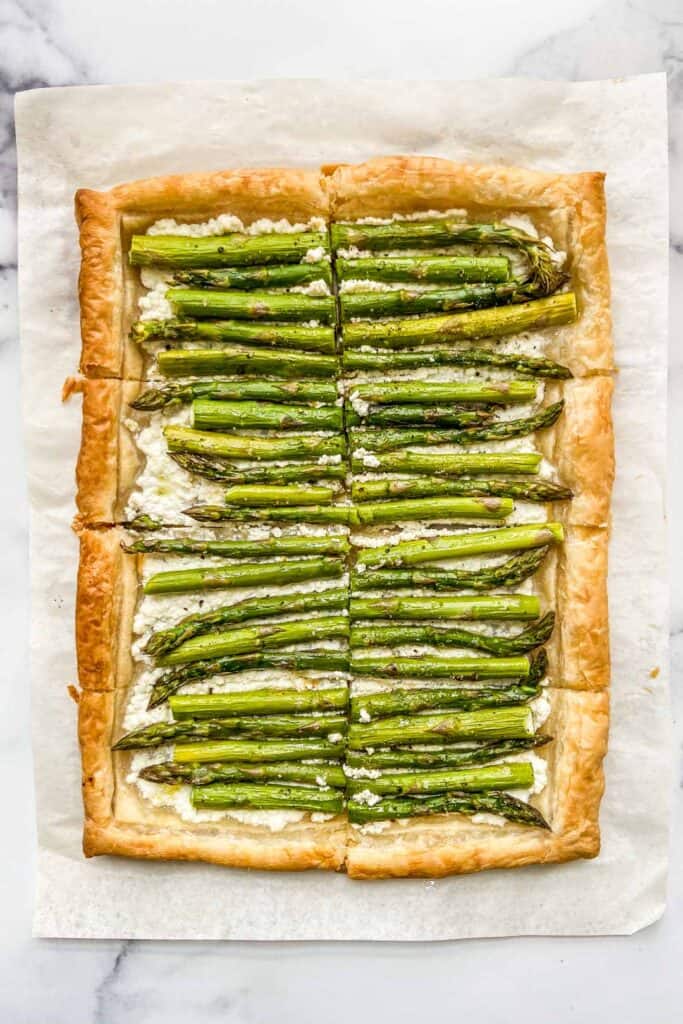 An asparagus tart on a piece of parchment paper.