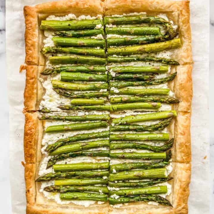 An asparagus tart on a piece of parchment paper.