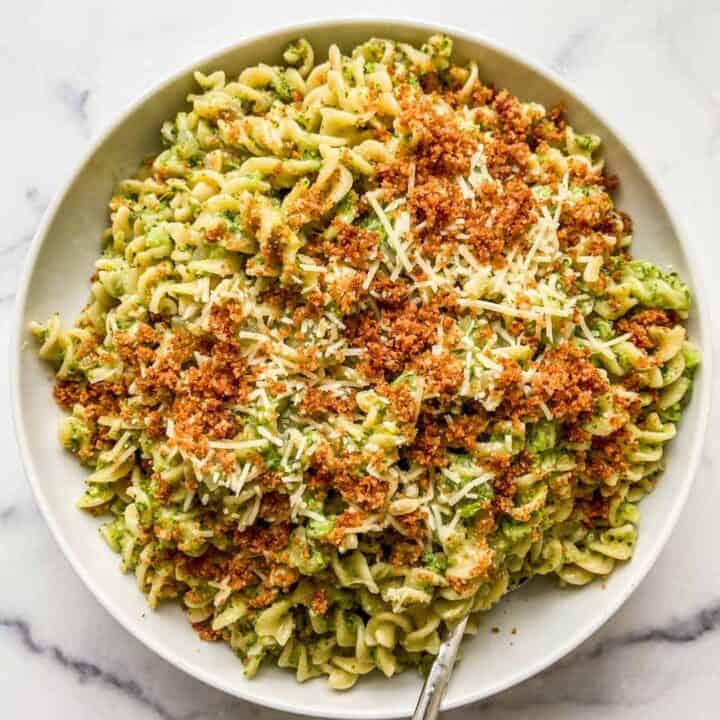 Broccoli pasta in a large serving bowl with a spoon.