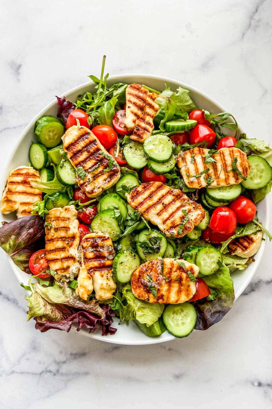 Overhead shot of grilled halloumi salad.