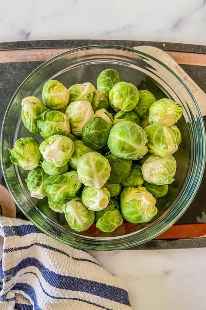 Fresh Brussels sprouts in a glass bowl.
