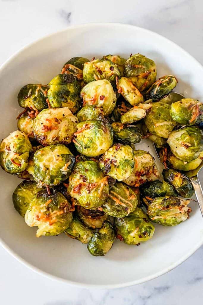 Crispy smashed Brussels sprouts in a serving bowl.