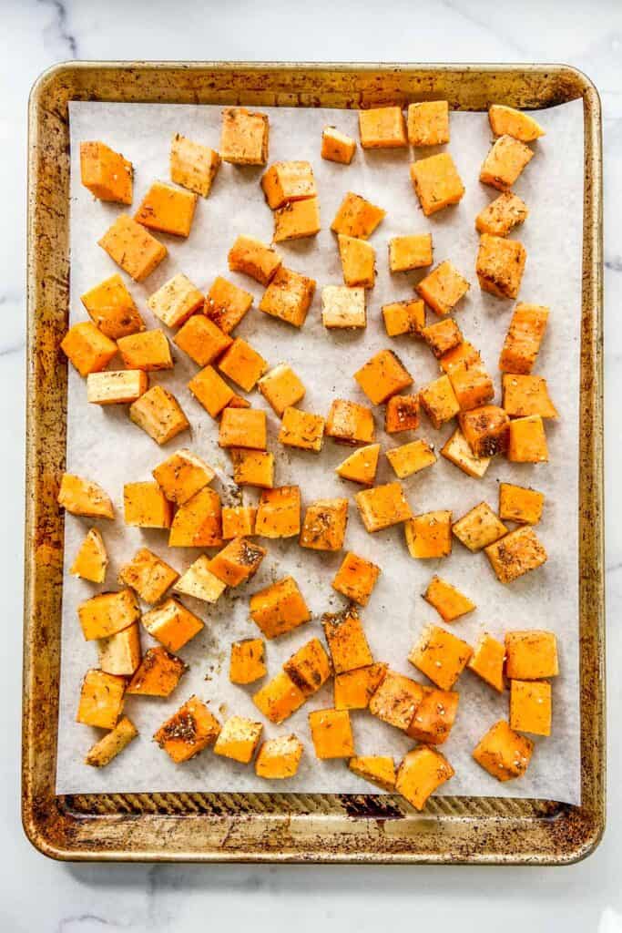 Diced butternut squash on a baking sheet.