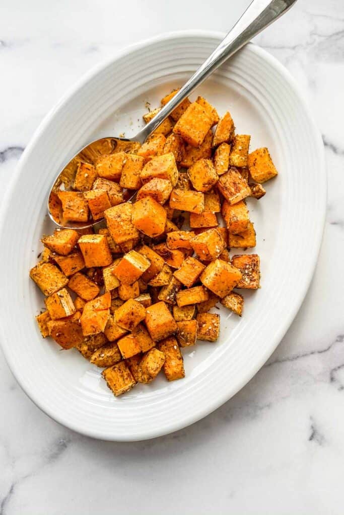 Butternut squash topped with za'atar on a serving plate.