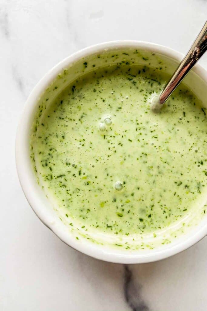 A ramekin of herby garlic yogurt sauce.