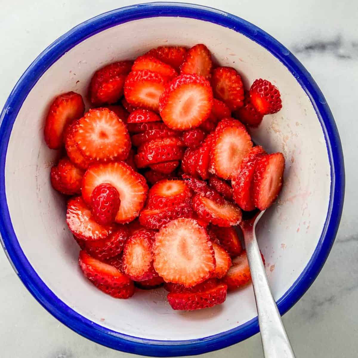 A bowl of orange blossom water strawberries.
