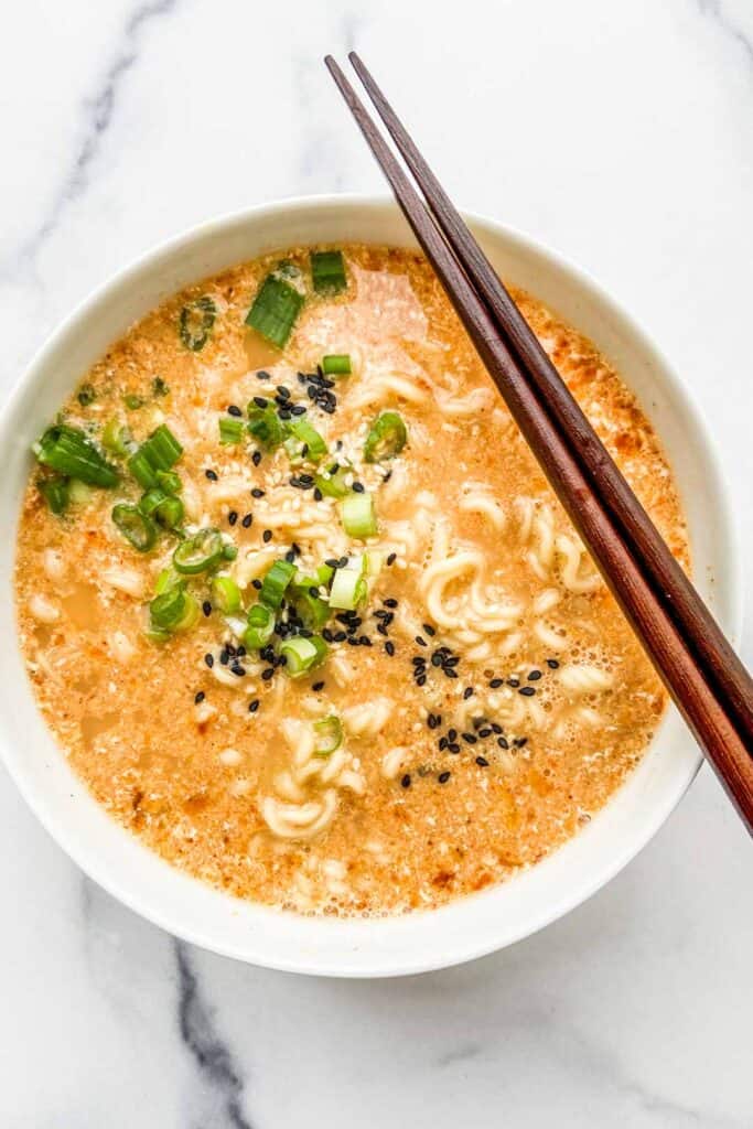 An overhead shot of a bowl of Japanese ramen with chopsticks resting on the bowl.