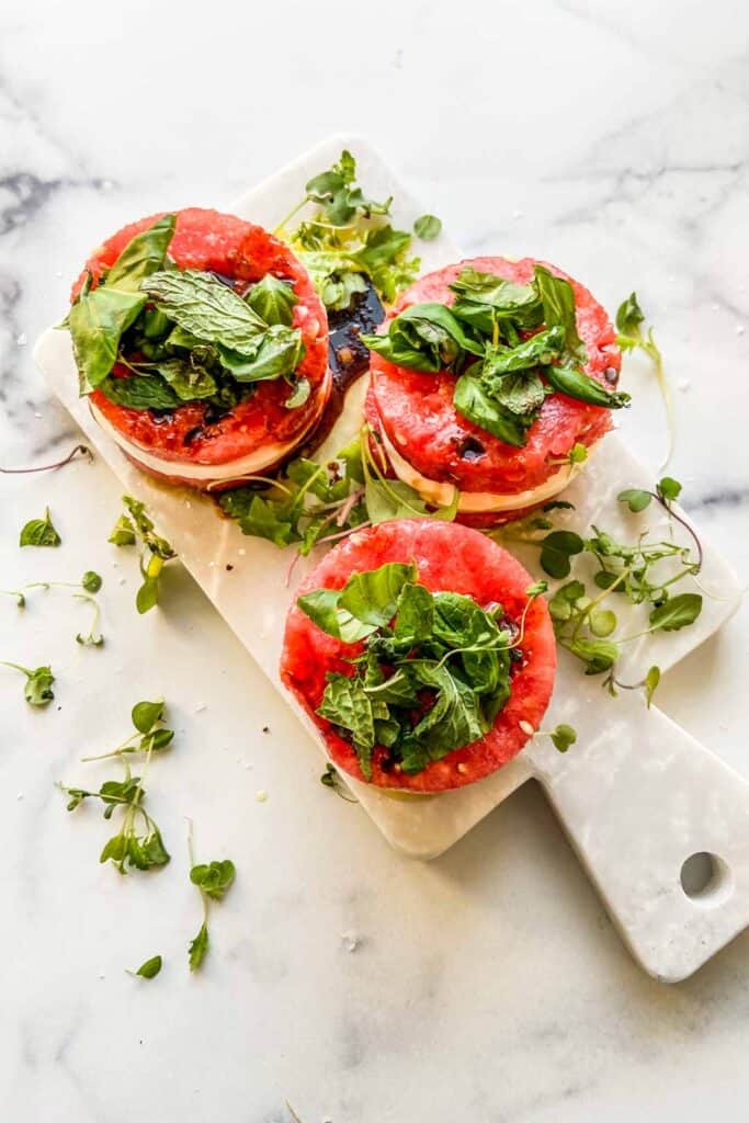 An overhead shot of three stacks of watermelon mozzarella salad.