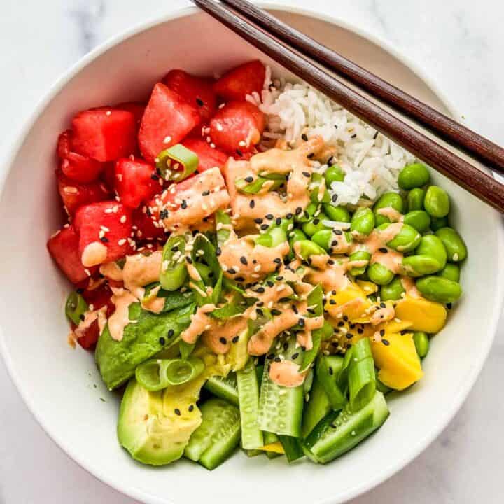 An overhead shot of a bowl of watermelon poke with chopsticks resting on the bowl.