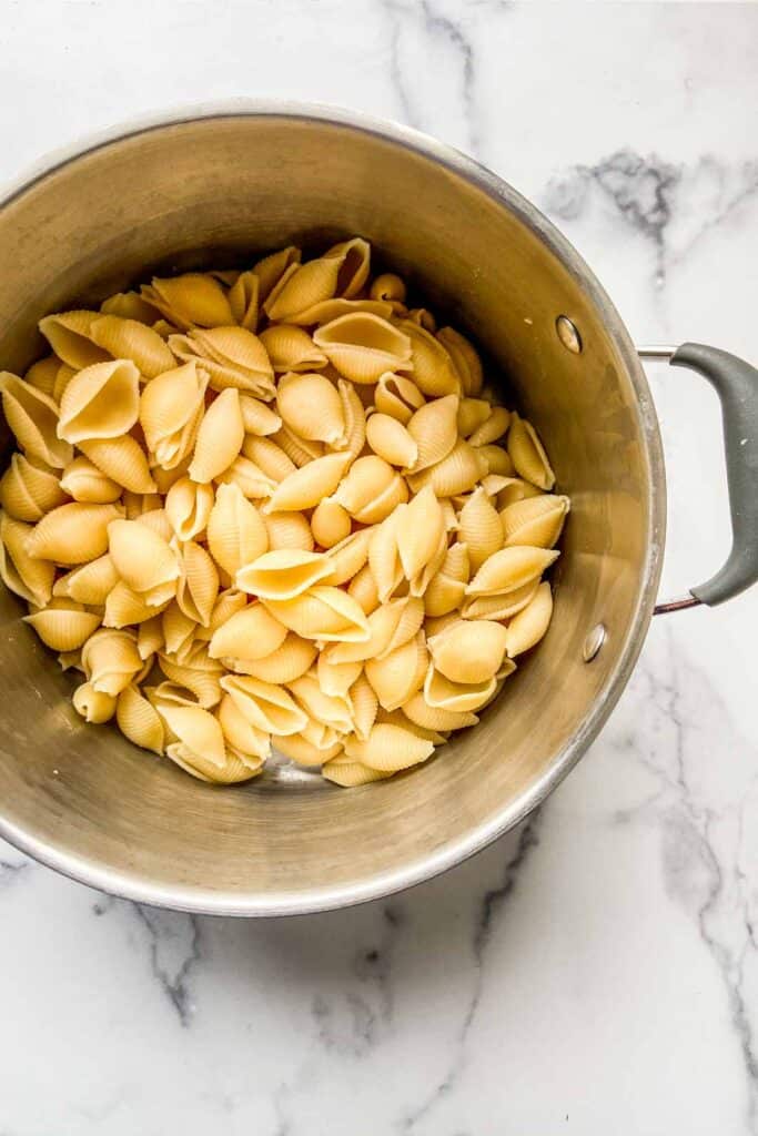 Cooked pasta shells in a large pot.