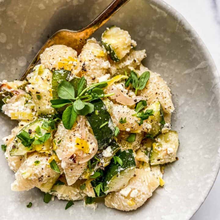 A bowl of feta, zucchini, and leek pasta.