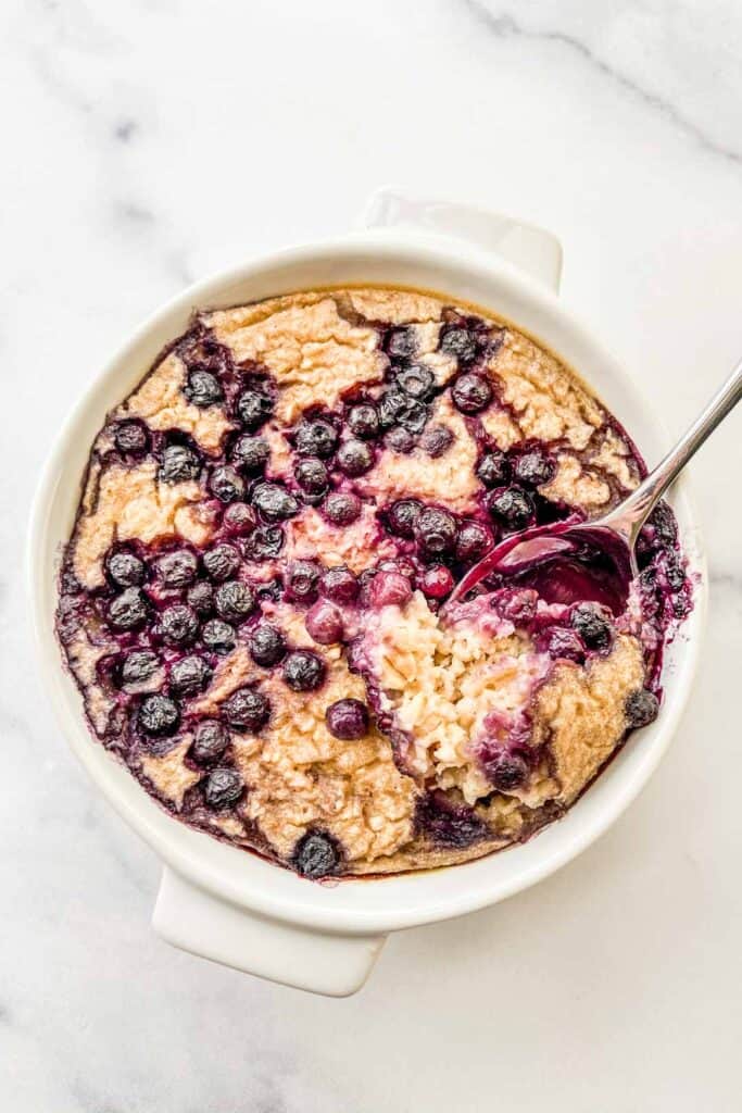 An overhead shot of a ramekin of blueberry baked oats.