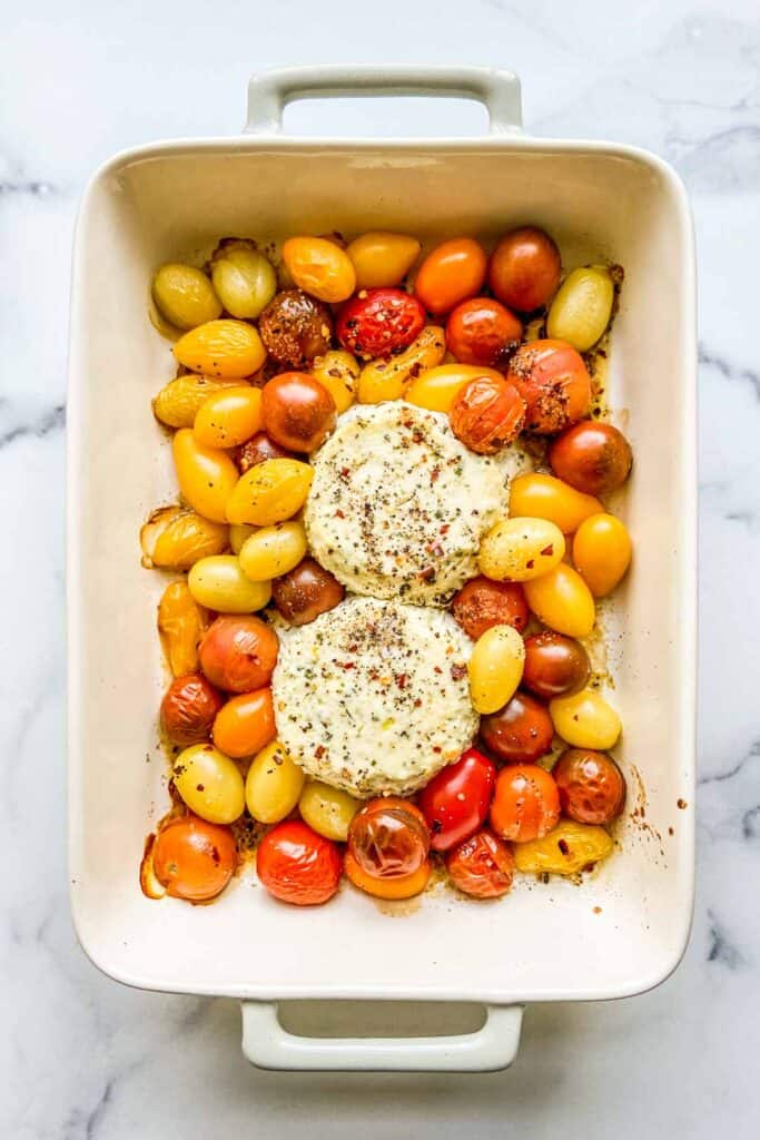 A baking dish with roasted Boursin and cherry tomatoes.