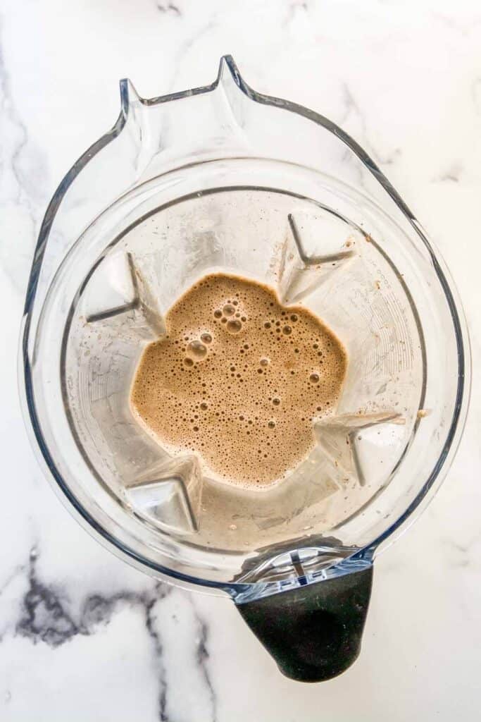 An overhead shot of a blender with blended oats.