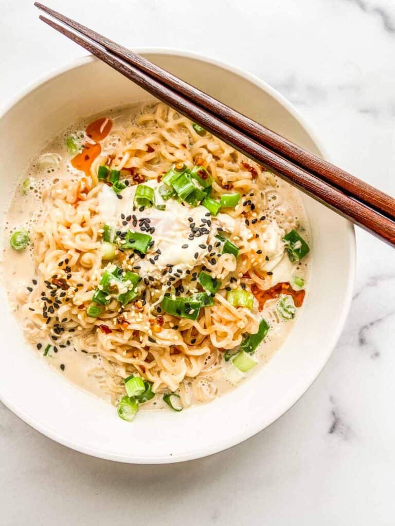 An overhead shot of a bowl of ramen with milk.