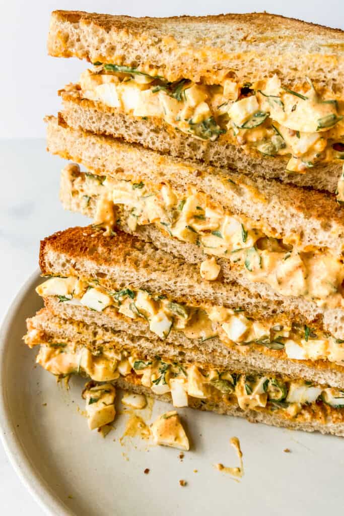 A stack of egg salad sandwiches