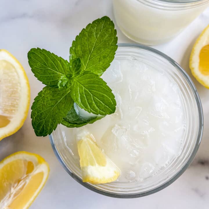 A closeup of a glass of creamy lemonade.