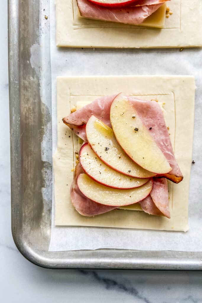 A closeup shot of a ham cheese and apple tart before it goes in the oven.