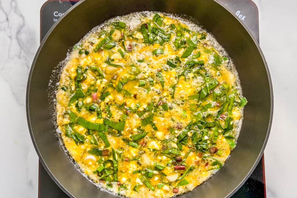 A ramp omelet cooking in a pan.