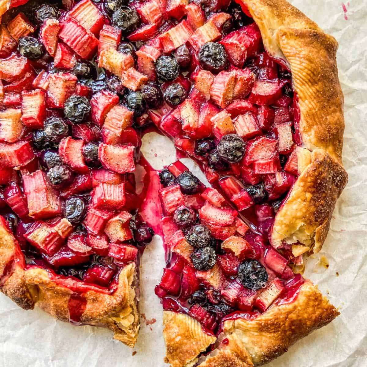 Blueberry rhubarb galette on parchment paper.
