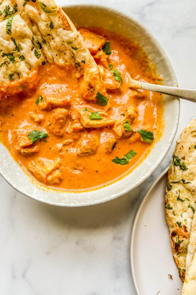 An overhead shot of a bowl of chicken tikka masala.