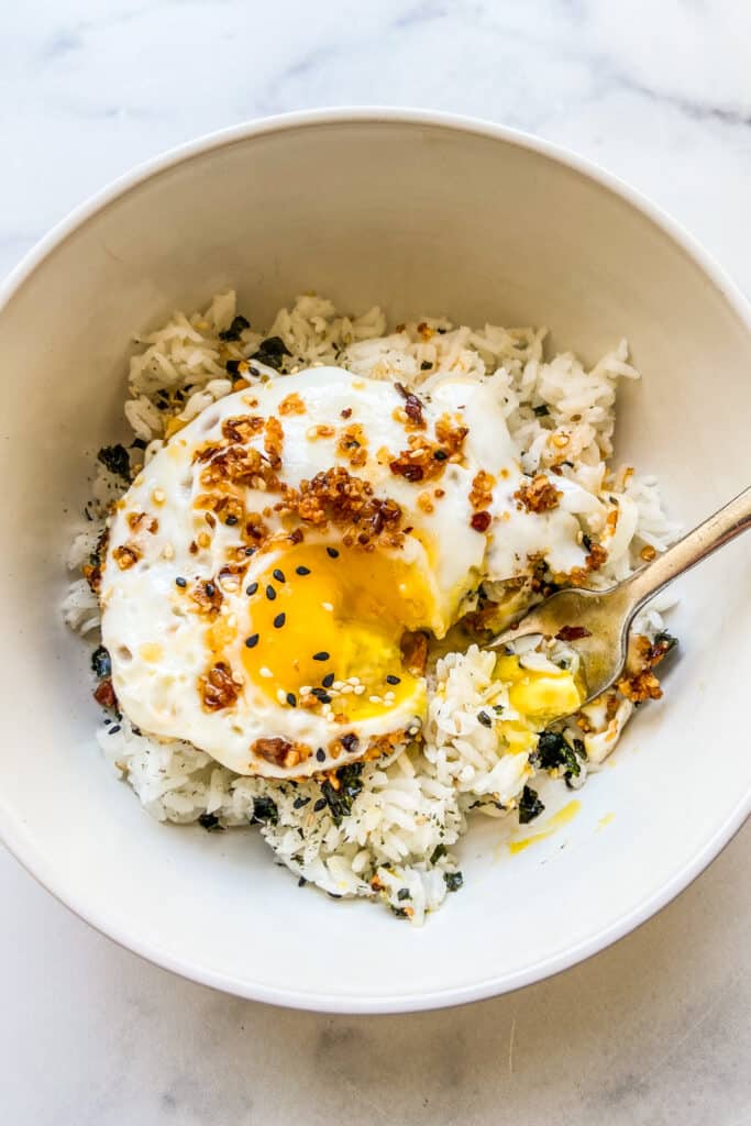 A bowl of chili oil eggs served over rice and furikake.