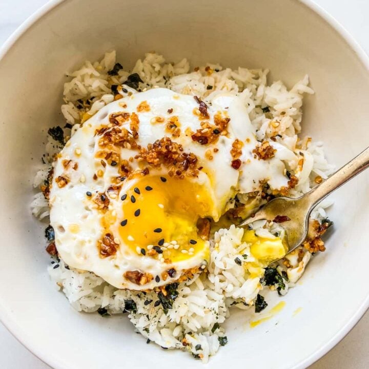 A bowl of chili oil eggs served over rice and furikake.