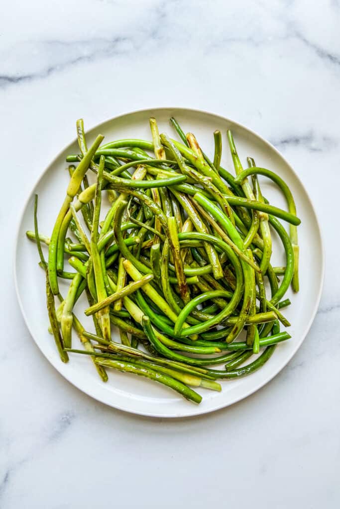 A plate of sautéed garlic scapes.