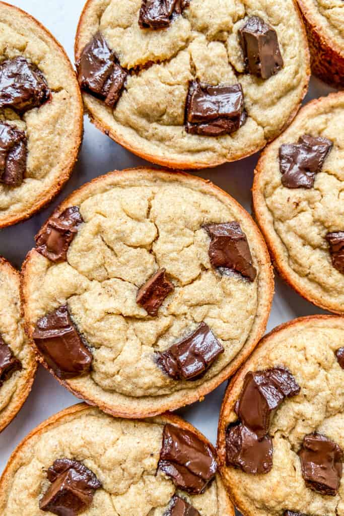 A closeup shot of banana muffins topped with chocolate.