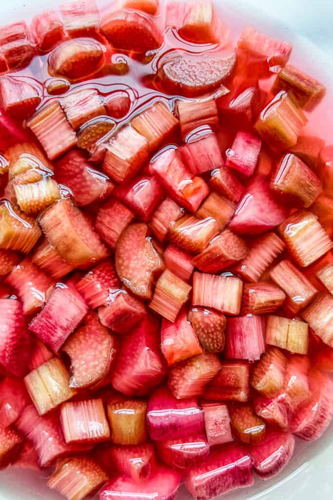 A closeup of rhubarb in sugar and vinegar.