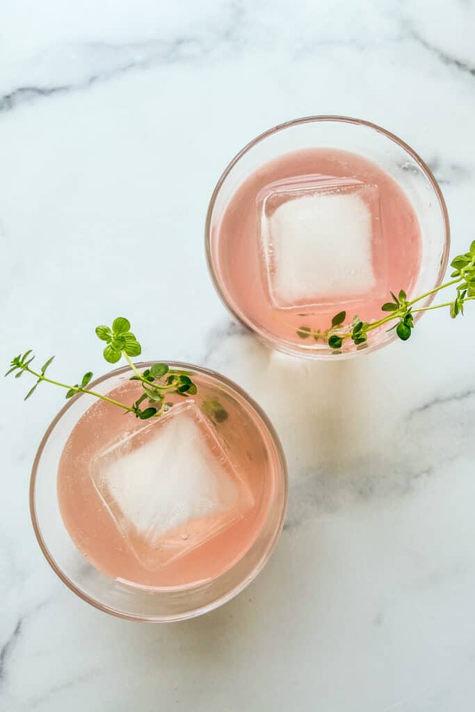 Two glasses of rhubarb shrub cocktail.