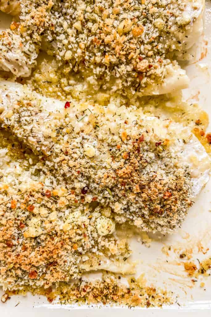 A closeup shot of crispy haddock in a baking dish.