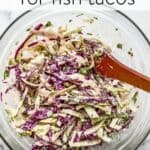 Cabbage slaw for fish tacos in a glass bowl.