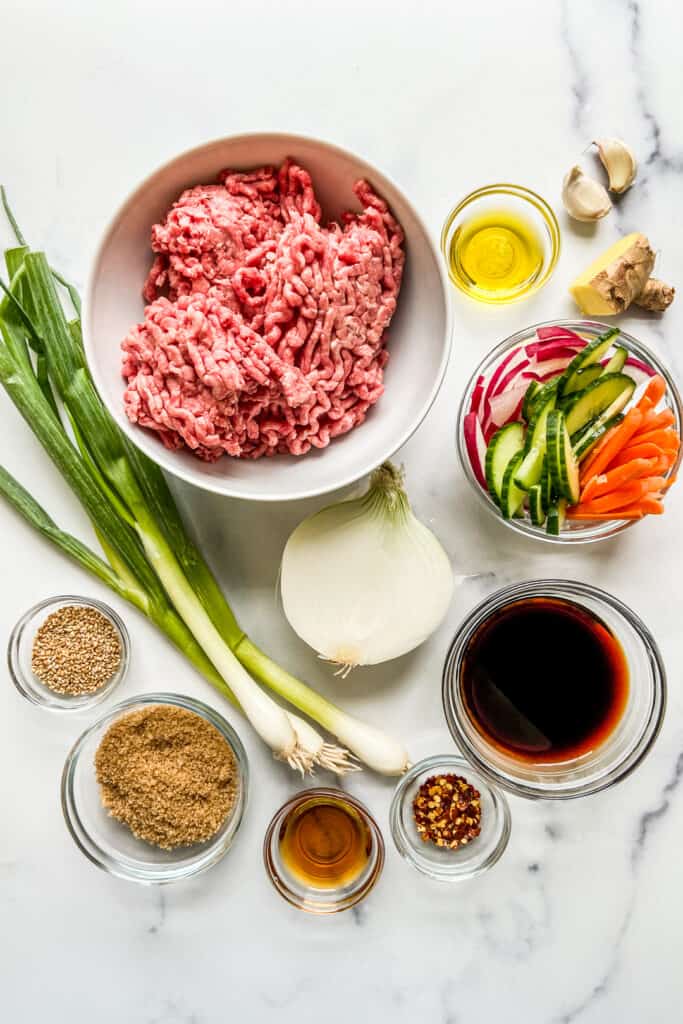 Ingredients for korean ground beef on a marble background.