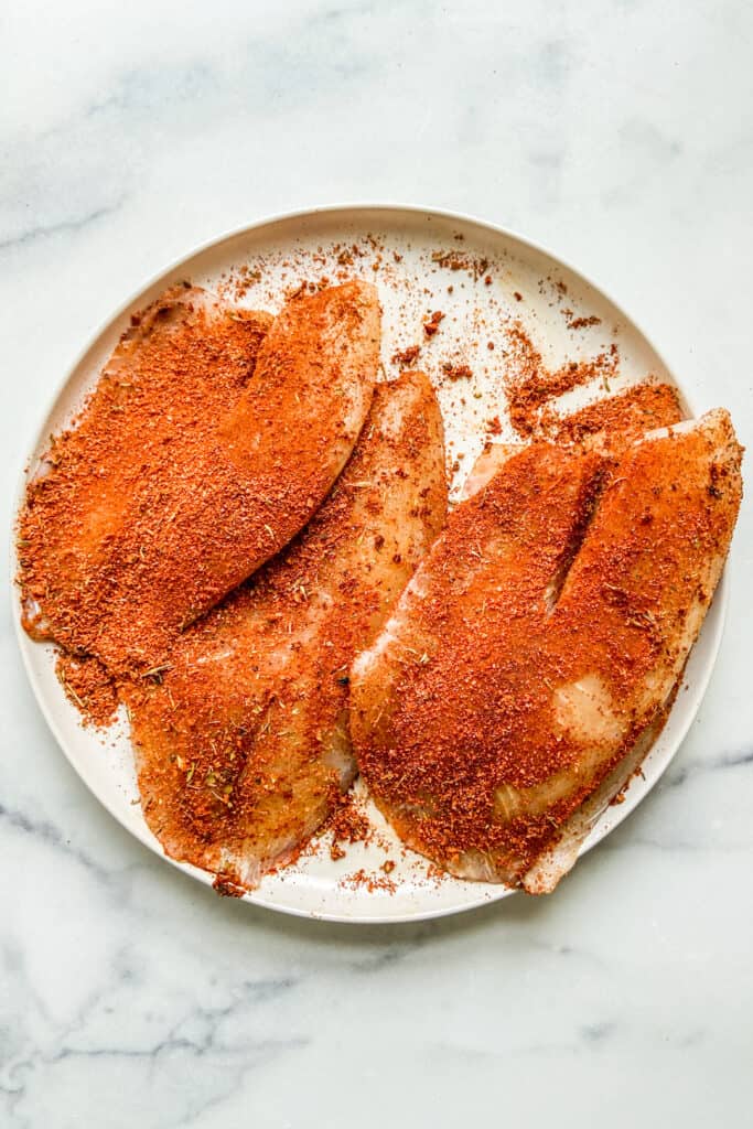 Tilapia topped with blackening seasoning.