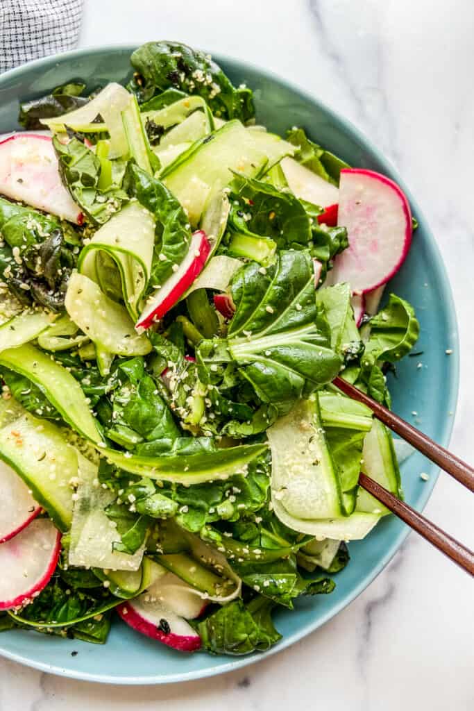 Tatsoi salad is a blue serving bowl.