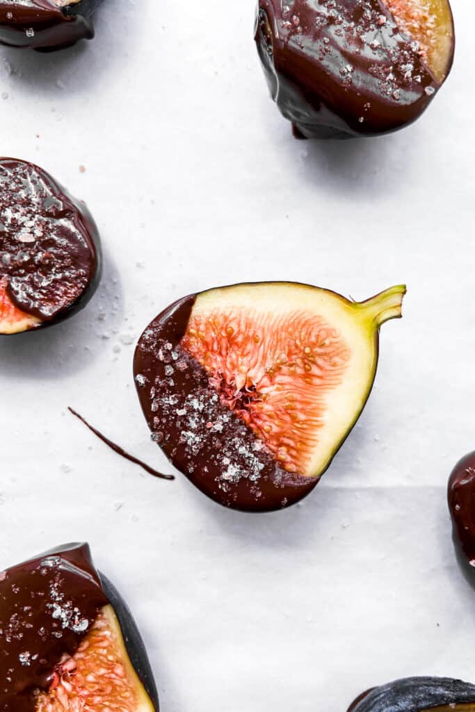 A closeup shot of dark chocolate dipped figs.