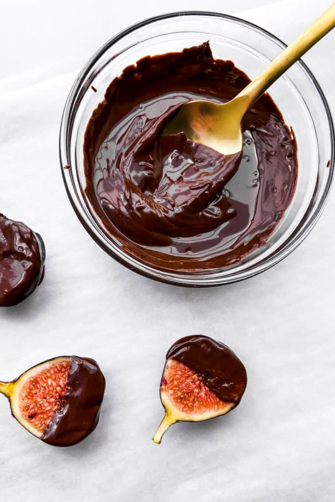 Melted dark chocolate in a glass bowl.