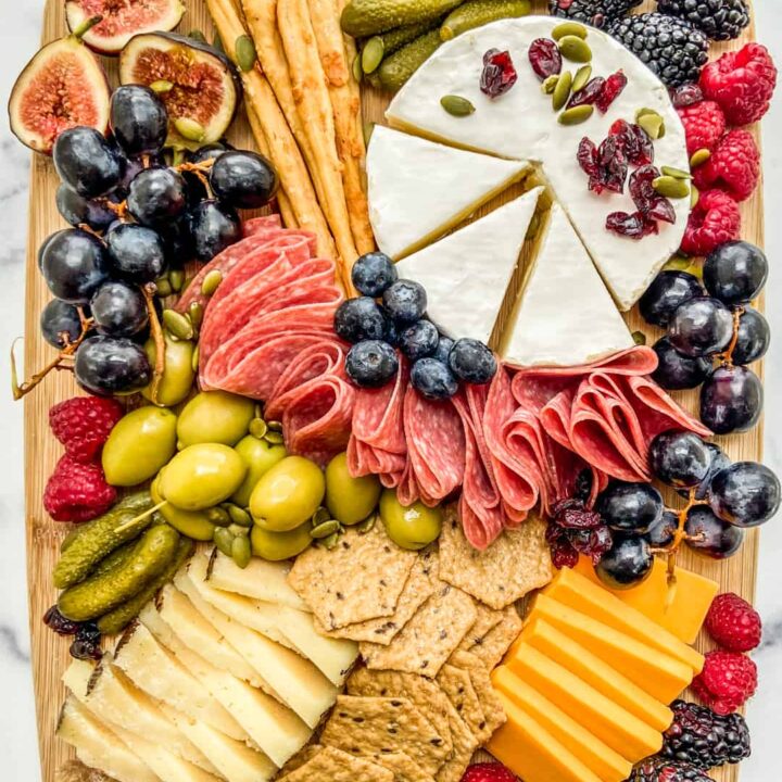 An overhead shot of a fall charcuterie board on a wooden board.