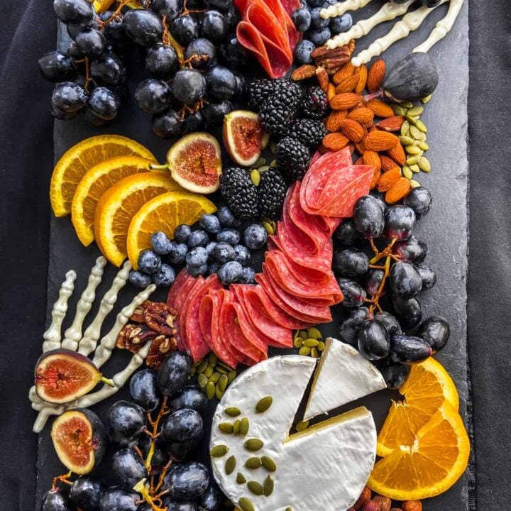 An overhead shot of a halloween charcuterie board on top of black fabric.