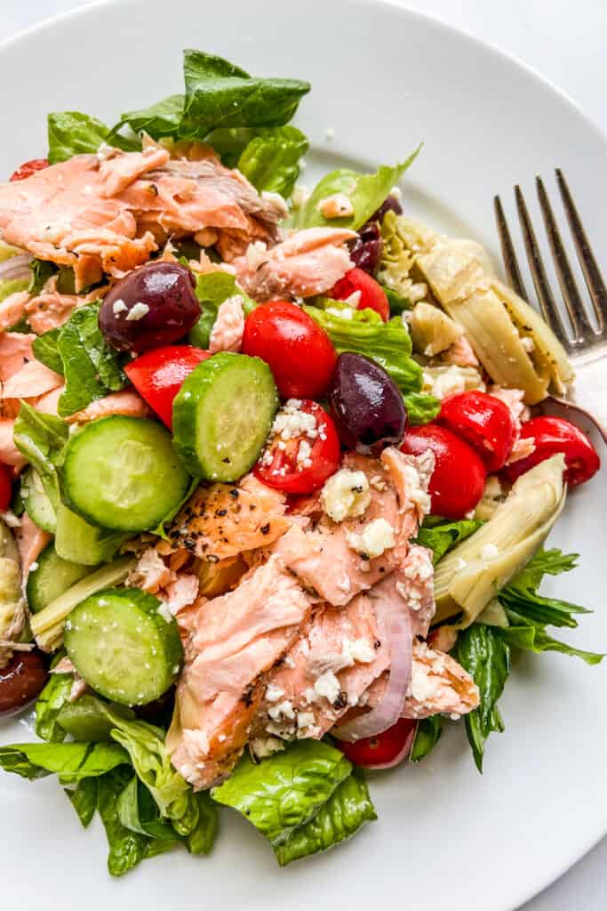 A closeup shot of Mediterranean salmon salad on a plate.