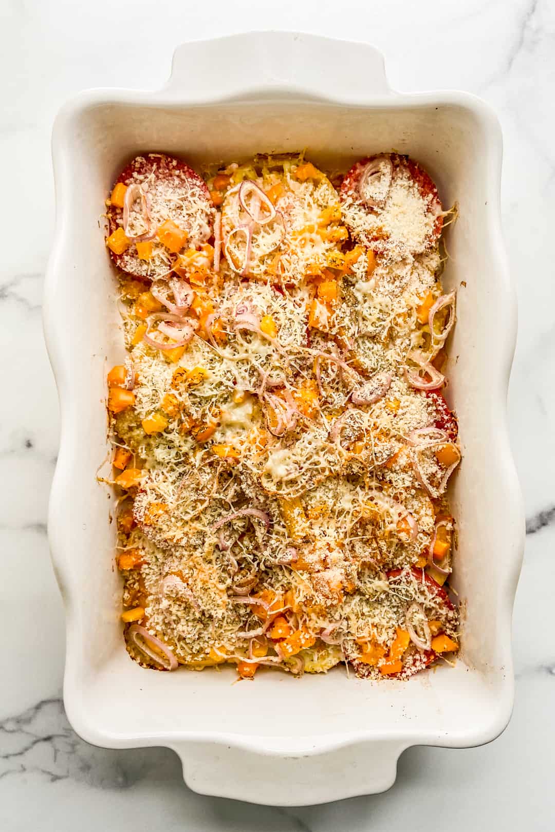 An overhead shot of a tomato squash gratin.