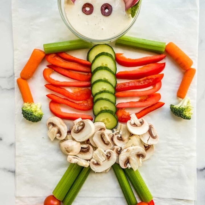 An overhead shot of a skeleton made out of cut vegetables.